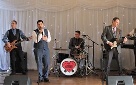 live wedding party band called the beathearts playing a live set at a wedding at Alfreton hall in front of a white backdrop
