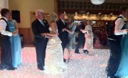 father daughter dance on white twinkle dance floor during wedding reception party in nottinghamshire 